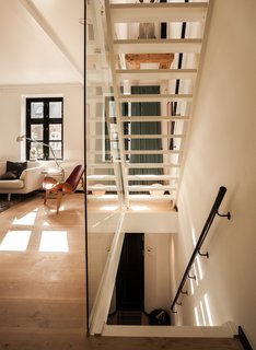Urban Renewal - Photo 1 of 7 - "From the day we got our house, I knew exactly how I wanted it done," says Mia Dalgas, who led the renovation of her family’s 1880s home in Copenhagen’s Potato Rows district. One of the biggest transformations was the addition of a glass-enclosed lacquered wood staircase.