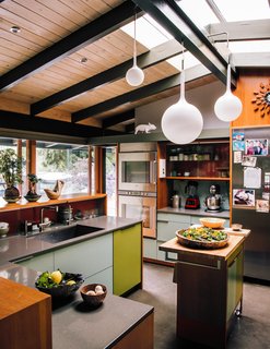 "Maintaining sight lines to the outdoors and the adjacent den, we introduced a connectivity that transforms the kitchen into the center of family life," Alice Fung says. 