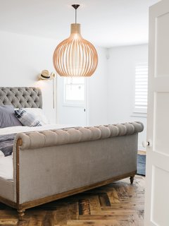 Adding a partial second floor accommodated bedrooms for Lena; her son, Wylie; and her daughter, Teddy. The master bedroom features a Chesterfield bed from Restoration Hardware and a pendant by Seppo Koho. "I saw tons of houses that were done and a few that needed redoing," says Lena. "This one was small, but it made sense."