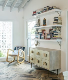 Broden gave the formerly low-ceilinged living room a high pitch and added more windows for light. For the floors, Lena chose salvaged oak hand-laid in a herringbone pattern. The Roar + Rabbit dresser is from West Elm.