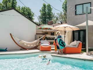 In the backyard, Lena combined a hammock from a former home with Maya chaises from Room & Board. A Woolly Pockets green wall system holds a variety of succulents. "They’re beautiful and architectural," Lena says of the plants. "And I can’t kill them, which makes me so happy."