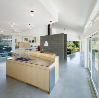 A Suburban Vancouver Home Edits its Privacy Settings - Photo 3 of 5 - The kitchen includes custom ash cabinets made by JMV Woodworks paired with stainless-steel countertops.