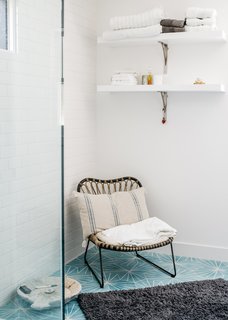 Dandelion cement tiles from Marrakech Design adorn the master bathroom. The chair is from Lawson Fenning. 