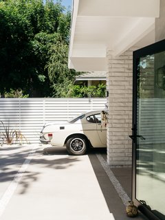 A crisp concrete pathway leads to the entrance. 