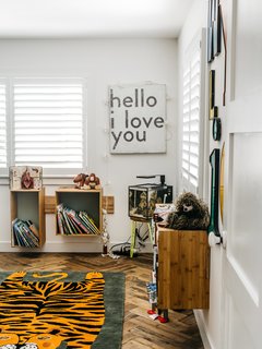 Wylie’s bedroom features a rug from the Land of Nod and a sign from a local shop. "I put the shelves up myself on my seventh attempt," Lena says. "If I move them, I guarantee you’ll see nineteen holes."