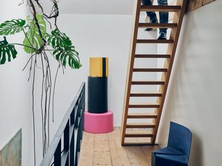 A stack of foam poufs from Venlet’s colorful, candy-inspired Let’s Drop collection joins his blue, powder-coated Cake chair on the third-floor landing. 