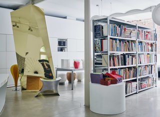 Books, models, and more prototypes—including the 1991 Powder Horse stool, composed of concave stainless-steel surfaces—fill Venlet’s atelier. 