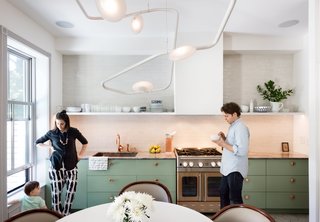 Focus on Furniture - Photo 1 of 3 - The couple’s bold mix-and-match sensibility applies most unconventionally to the material palette; nearly every surface is different from the next. The cook station pairs a copper Watermark faucet with an Italian marble countertop, a copper-toned stainless-steel range from Blue Star, and a backsplash of masonry Foundation Brick tile by Ann Sacks. 