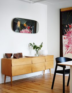 In the opposite communal area, which is separated by the kitchen, a Reflect sideboard by Søren Rose holds a white Cosy lamp by Harri Koskinen and a vase by Andreas Engesvik. 