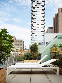 The top terrace, outfitted with Eos lounge chairs from Design Within Reach, has an unobstructed view of Herzog & de Meuron’s 56 Leonard Street.
