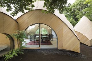 How to Age Gracefully in Japan - Photo 2 of 6 - Detail of the kitchen's curved wall made from concrete and wrapped in Japanese cypress. 