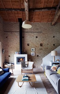 By the Saey fireplace, a wicker chair from Malawi echoes the lines of Pinch’s Willo table. Matching other pieces to their line "is not an exact science," Oona says, "just an innate reaction to things we love."