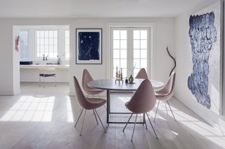 A Recent Trip Leaves Us Dwelling on Denmark - Photo 6 of 14 - The first floor of the home features an open plan that combines the kitchen, dining room, and a small study. Drop chairs by Arne Jacobsen surround a PK58 table by Poul Kjærholm. The study includes the designer's three-legged PK11 chair alongside sculptures by artists and the couple's children. 
