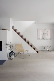 A Recent Trip Leaves Us Dwelling on Denmark - Photo 7 of 14 - The wicker PK22 lounge chair and a foldable PK91 stool made from steel and canvas sit by the staircase on the first floor. 