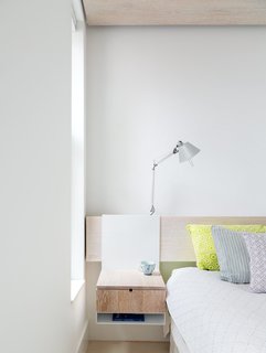 This 60-Square-Foot Structure Divides and Conquers in a Manhattan Renovation - Photo 2 of 8 - Rather than clutter the master bedroom with furniture, Frame Design Lab created a system where night stands hang from a wall-mounted headboard. 
