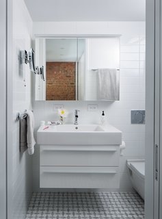 In the bathroom,a little-used tub was replaced by a streamlined shower. Both the Duravit medicine cabinet and the Kimball & Young makeup mirror feature built-in LED lighting.