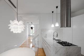 Spotlight on Portugal: 7 Epic Modern Spaces - Photo 4 of 7 - Natural materials are contrasted with white surfaces. After 120 years, this Portuguese building required a little more than just a fresh coat of paint. Tiago do Vale Architects revived the 19th-century dwelling by retaining original details like wooden window frames, the traditional eave, and ceilings while updating the entire structure with a minimalist's touch.