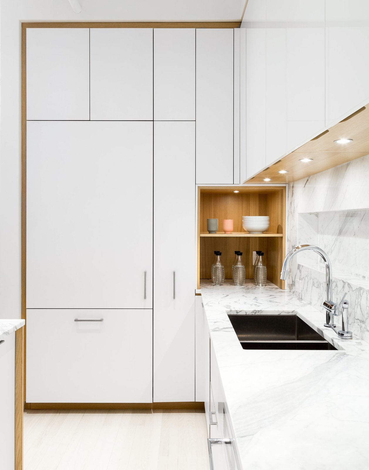 The kitchen was designed in collaboration with Henrybuilt. The laminate cabinets are paired with a marble countertop by SMC Stone.