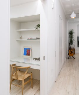 This 60-Square-Foot Structure Divides and Conquers in a Manhattan Renovation - Photo 6 of 8 - Inside the Cube, a Wishbone chair by Hans Wegner pulls up to a built-in painted lacquer desk. 