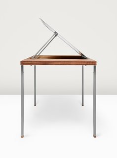 Adjustable legs, inspired by the pocketknife’s slender housing for tookpicks and tweezers, elevate the Convertible Table from coffee table to desk height. A metal panel that rises from the walnut surfaces reveals a one-and-a-half-inch-deep compartment that acts as a drafting board. 