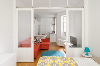 All furnishings were purchased on a budget. The rug and Friheten sleeper sectional in the living room, the Luftig oven hood, Norrsjön sink, Sektion cabinetry, and countertop in the kitchen, and the small dining counter with Glenn bar stools were all sourced from IKEA.