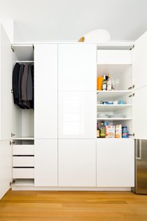 This 390-Square-Foot Renovation Is Compact Yet Comfortable in Greenwich Village - Photo 7 of 9 - In the kitchen, a single Sektion wardrobe from IKEA is used to stow both clothing and various food and dining items. Throughout the apartment, Krajewski replaced the time-worn flooring, installing new white oak planks by Hull Forest with a buffed oil finish by Waterlox. 