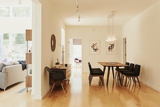 An array of Fucsia pendants by Achille Castiglioni illuminates an Alden dining table by Eastvold and Chanel chairs from Article. The Eames Molded Armchairs are from Herman Miller’s polypropylene edition. 