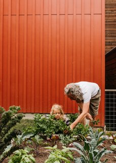 With 142 residences on just eight acres, the Grow Community development brings new density to Bainbridge Island, near Seattle. Architect Jonathan Davis, in the garden with his daughter, Dashwood,designed the project’s first phase, The Village. Inspired by One Planet Living sustainability principles, it was imagined as an assemblage of net-zero homes. 