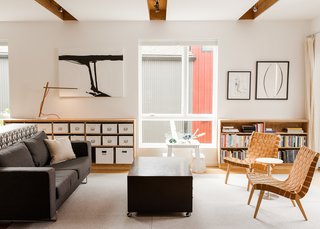 The Davises’ living room is filled with modern designs, including two lounge chairs by Jens Risom for Knoll and a BoConcept sofa. Mary Jo created the artwork.