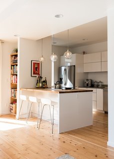 Marja Preston’s family lives in one of Grow’s "Everett" houses, with three bedrooms in 1,846 square feet. In their kitchen, West Elm pendants hang over a counter of myrtle butcher block sourced from Green Home Solutions.