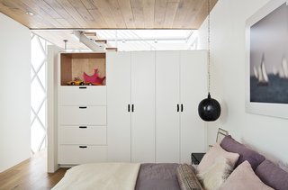 Such Great Heights - Photo 13 of 13 - The master bedroom is furnished with an Egyptian lantern from l’aviva home, built-in closets, and bedding by Restoration Hardware. 