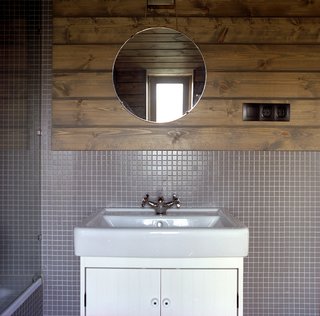 By the entrance to the master suite, a mirror sits on a table of Ovchinnikov’s design. 