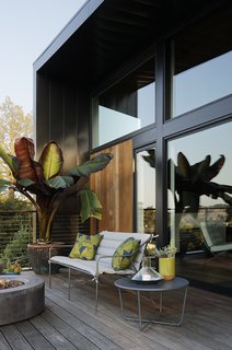 The barware, candle holders, dining set, lantern, terracotta planters, outdoor seating, and side table are all from the Modern by Dwell Magazine collection for Target. The fire pit is from Restoration Hardware. 