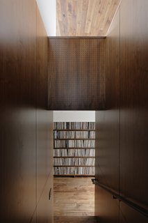 The adjacent volume houses the galley kitchen; the Ball clock is by George Nelson Associates.A portion of Jack’s massive collection of more than 10,000 records is displayed in a low-slung walnut shelving unit built along the upstairs stairwell entry. 