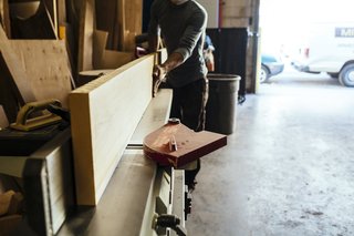 How to Shape a Shoji, Step by Step - Photo 1 of 8 - After selecting the lumber, craftsman Naotaka Hakamada brings it to a jointer to ensure the wood is straight before cutting into smaller pieces with a table saw. 