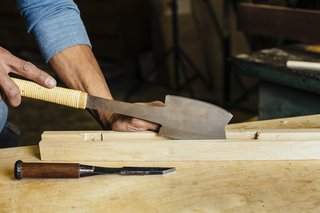 How to Shape a Shoji, Step by Step - Photo 4 of 8 - Using a Japanese handsaw, the woodworker, in just one stroke, cuts a channel into the wood, <br>creating a slot for the rice paper. 