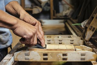 How to Shape a Shoji, Step by Step - Photo 5 of 8 - Held in place by a wood frame, whetstones with varying grades of fineness are used to sharpen the blade.