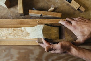 How to Shape a Shoji, Step by Step - Photo 6 of 8 - Hakamada carefully pulls a plane across the wood's surface. He will use only one stroke to make sure that the surface is even. It is never sanded. 