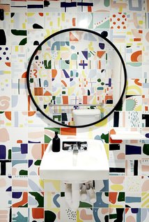Santos and his girlfriend, Jessie, hand-painted the tiles in the bathroom; it's become a popular spot for guests to snap selfies. 