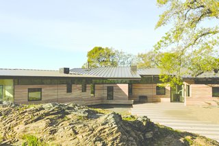 Gawthrop, an avid hang-glider who is a member of the U.S. Soaring Team, wanted the home to evoke flight; the standing-seam roof from Metal Sale is held up by wire struts to resemble a plane’s wing. <br>In the foreground is the rock formation designer Alan Nicholson had excavated. 
