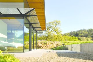 Sixteen-foot-tall glass walls, paired with seven-foot overhangs and three-foot solar screens, optimize the home’s passive climate control and capture views of the <br>valley that unfurls across the couple’s 160-acre property.