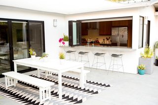 10 Ways to Use Rugs in Your Outdoor Space This Spring - Photo 3 of 10 - Bring asphalt patios and concrete backyards alive with rugs, plants, and monochromatic colors.