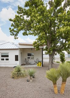 Surrounded by plants from yucca grower Hoven Riley, the casita’s porch shelters planters from Brown Dog Gardens and two Acapulco chairs. 
