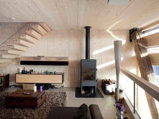 A Passive House in the Netherlands Embodies 5 Tips to Consider When Planning Your Own - Photo 2 of 5 - The pellet stove in the living room area serves multiple purposes including providing heat for the shower and the rooms on cold days.