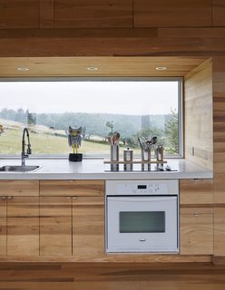 The focal point of the home is the long Alumicor window that reveals the slope of the site. 