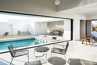 Comprised of stark whitewashed angles and box forms, the interconnected interior is focused around the pool and open walls in order to allow for seamless indoor/outdoor living. 