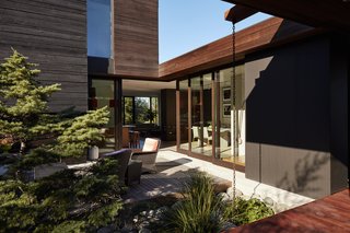 Greener Grass - Photo 2 of 14 - A builder by trade, Ian <br>served as general contractor, working with designer Eric Walter of mw|works. Three box volumes, conceived as "spaces within spaces," are configured around the open courtyard; local firm Wittman-Estes designed the hardscapes.