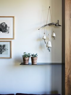 Greener Grass - Photo 6 of 14 - Personal keepsakes, like a mobile by Anne Siems, soften the slightly industrial aesthetic.