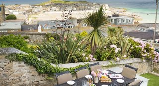 Escape For a Weekend Away at One of These Cornish Retreats That Fuse Old and New - Photo 8 of 14 - The cheery, five-bedroom Pednolver is a historical townhouse that offers ample room for large parties with three floors. The cinema space in the basement and spacious open-plan kitchen are ideal spots for gatherings with family and friends. 