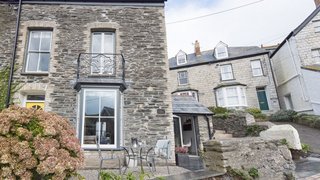 Escape For a Weekend Away at One of These Cornish Retreats That Fuse Old and New - Photo 12 of 14 - Designed by Cornish interior designer and home renovation expert Nicola O'Mara, Albany in Port Isaac is a peaceful haven decked in sea-gray wood panels, exposed slate walls, and midcentury furniture. 
